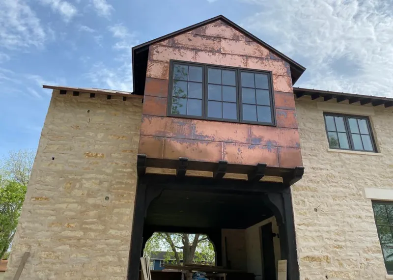 Copper metal panel facade on a stone building for Skylight Installation in Kemp Mill